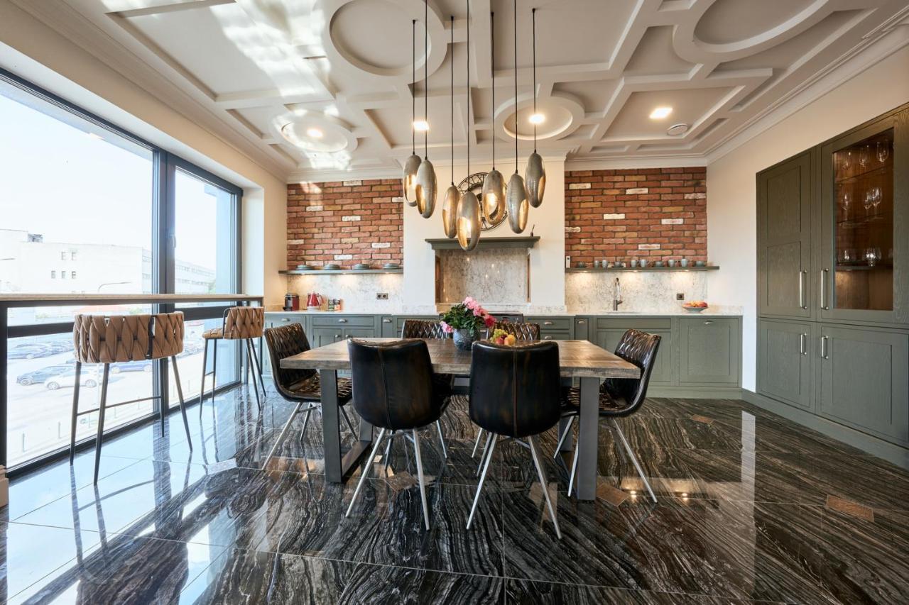 Designer kitchen with brick wall and marble floor