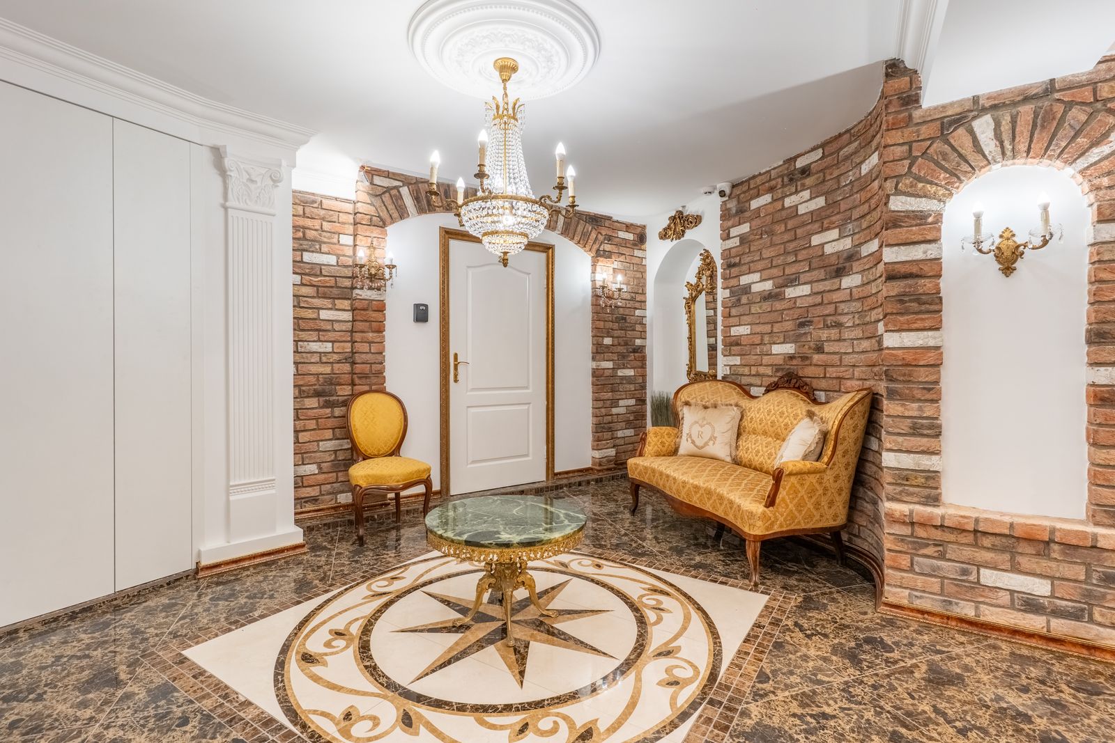 Candle-lit vaulted lounge with a marble compass-rose floor and chandelier — Underground Kingdom, Kaunas Old Town