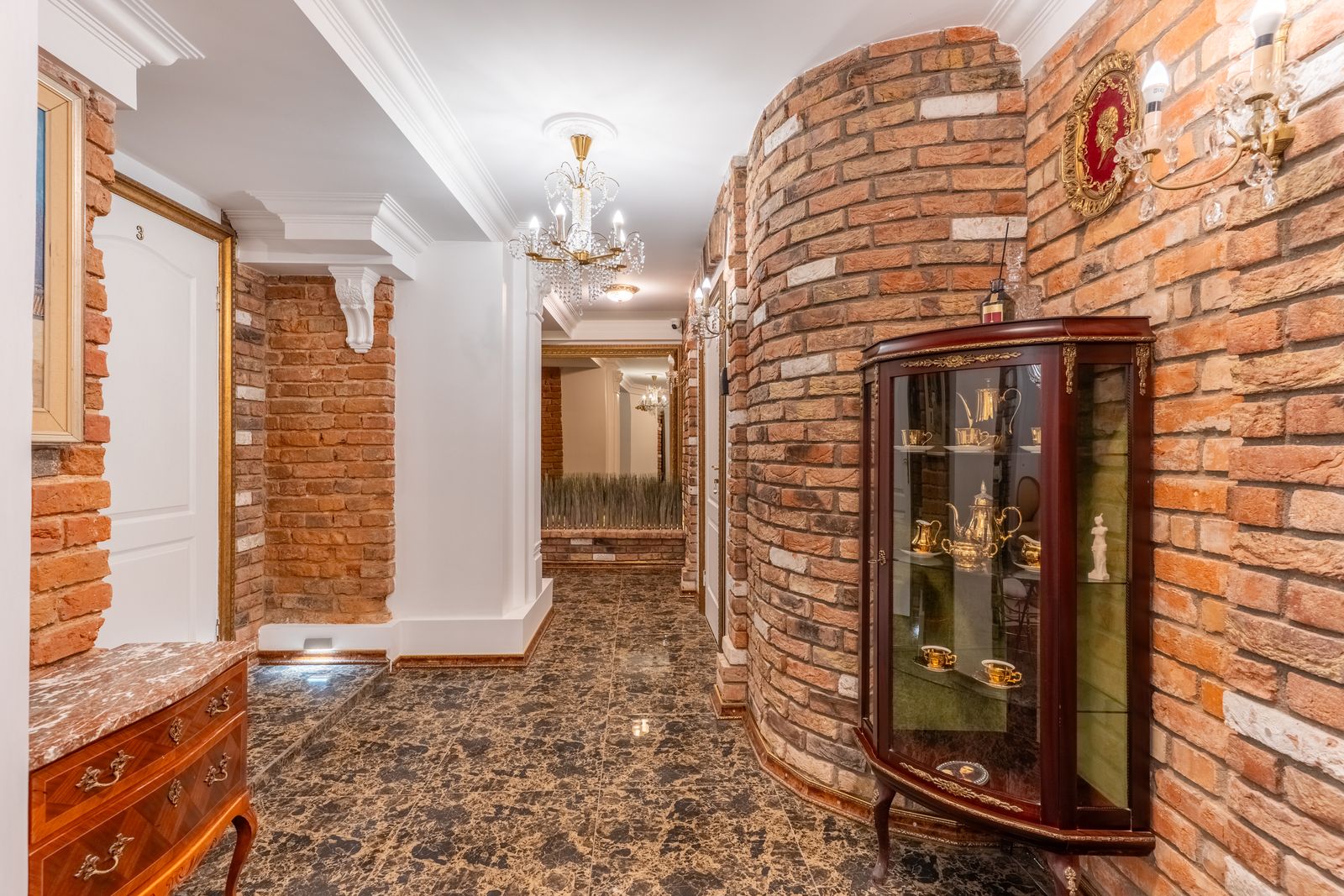 Brick-vaulted corridor connecting the private rooms — Underground Kingdom boutique stay, Kaunas