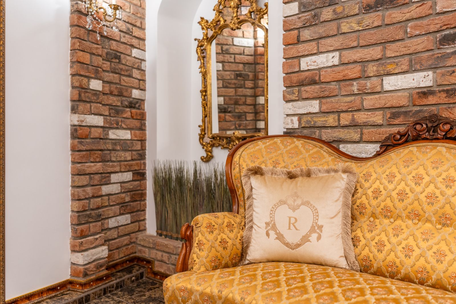 Antique sofa and armchairs in a brick-vaulted lounge — Underground Kingdom, Kaunas Old Town
