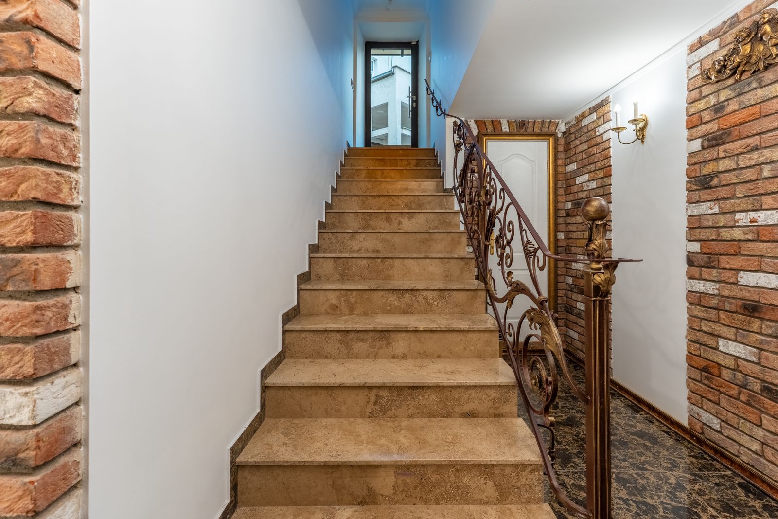 Wrought-iron staircase leading down to the vaulted cellars — Underground Kingdom, Kaunas Old Town