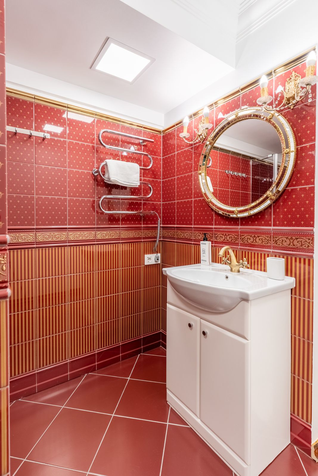 En-suite bathroom with vanity and round mirror — Underground Kingdom boutique stay, Kaunas